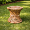 Woven wicker side table on a grassy lawn