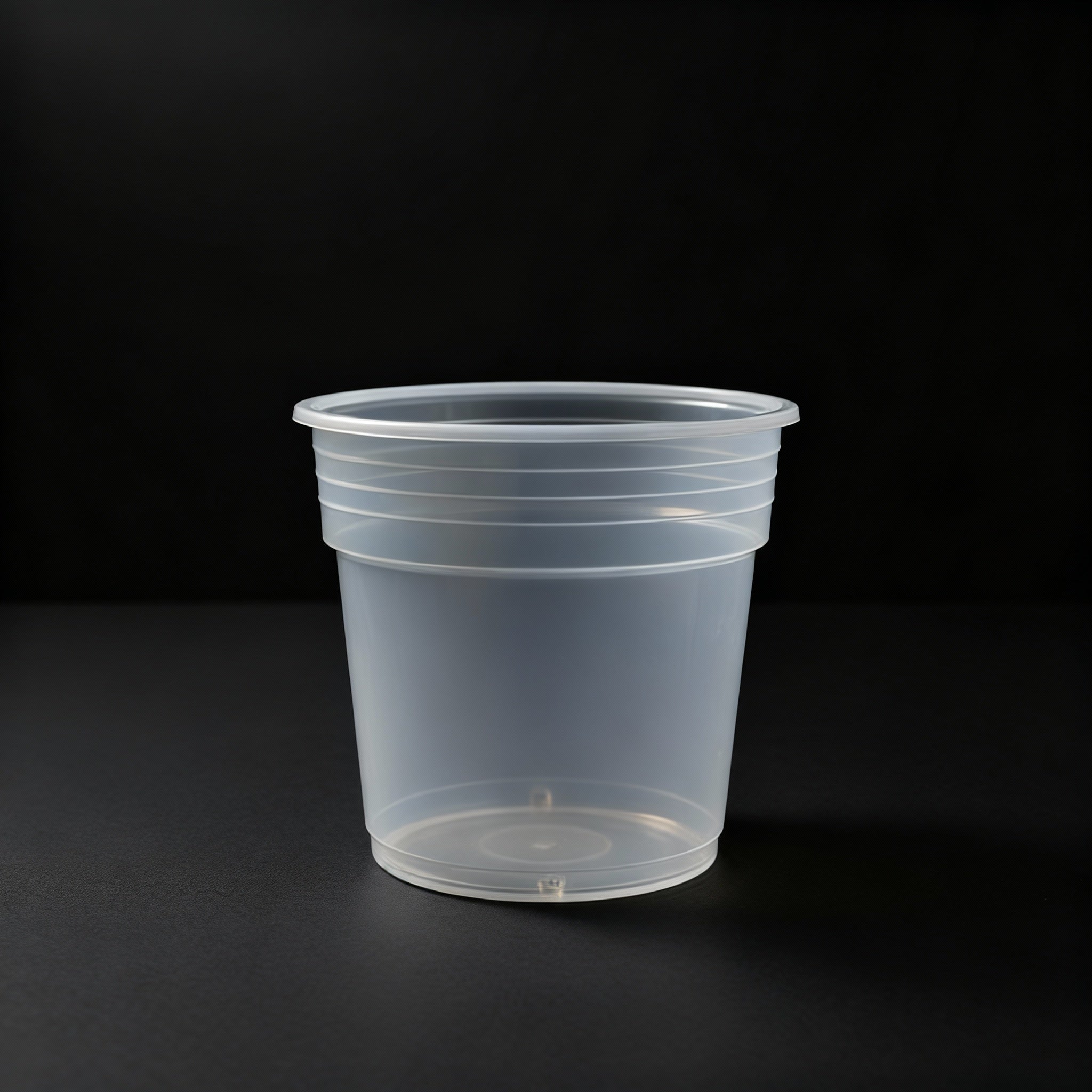Clear plastic pot on a black background